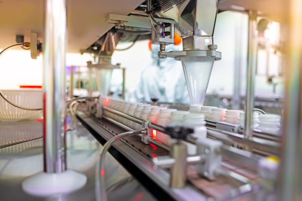  medicine bottles on the conveyor belt in pharmaceuticals
